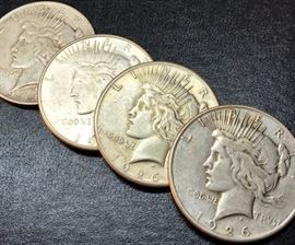 Four 1926 Peace Silver Dollars