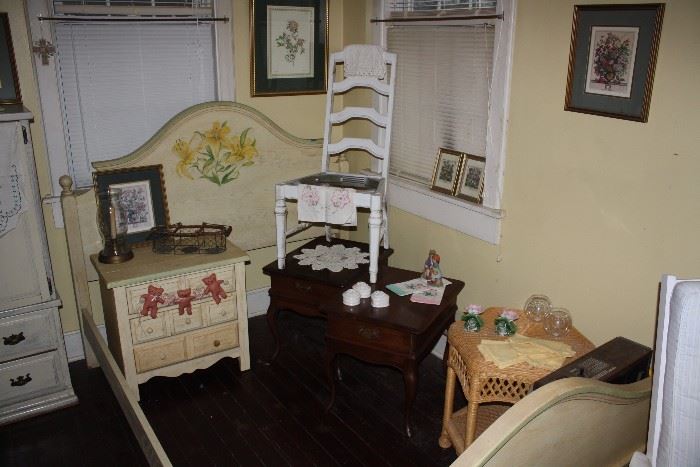 Variety of furniture items.  bed, ladderback chair, pair of wooden end tables, wicker table.  My favorite is on the left-white with 8 small drawers.  