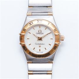 Women's Omega Constellation Wristwatch: A women’s Omega Constellation wristwatch in stainless steel with 18K yellow gold bezel, crown and accents. Features include roman numeral markers and dauphine hands.