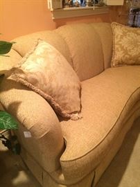 Impressive (like new) curved back, one cushion pale gold sofa and pillows