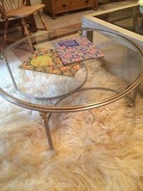Round glass top table has a matching sofa table.
