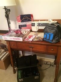 Singer sewing machine in cabinet and featherweight sewing machine