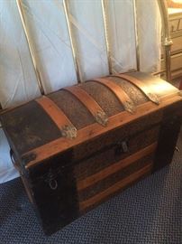 Dome top antique trunk; brass-like bed headboard
