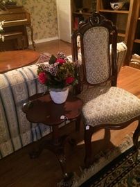 One of two matching parlor chairs; small side table
