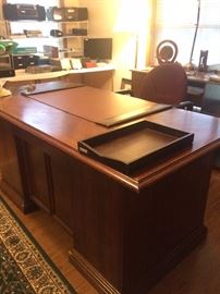 Large desk and many office supplies
