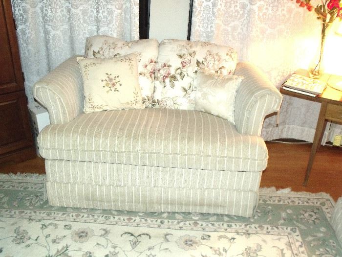 One of two matching love seats
