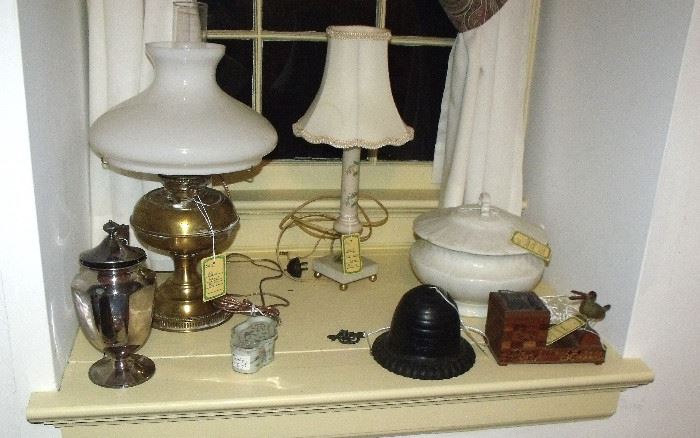 More oil lamps - note cast iron string dispenser and old bird cigarette dispenser