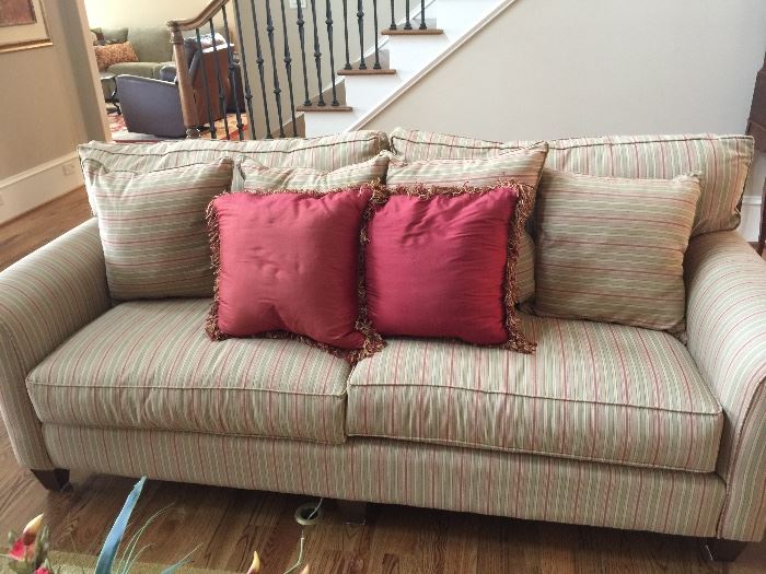 Upholstered couch with over-stuffed pillows