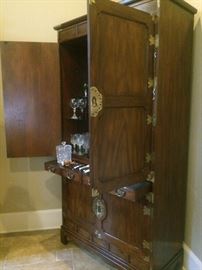 Asian style cabinet with ample storage --- serves as a bar.