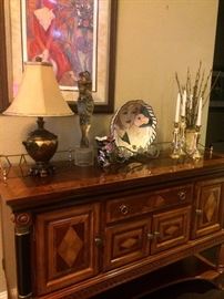 Server with beautifully inlaid wood; lamp, embracing couple statue, and other decor 