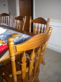 Dining room table with two leaves, 4 side chairs & 2 captain chairs. (1capt chair has broken arms-could be armless chair easily)
