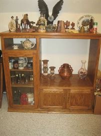 Open and closed shelving and storage, cowboy memorabilia on top with large eagle