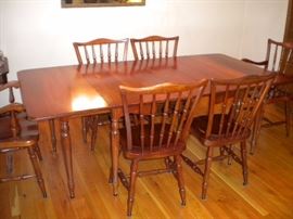 Stunning Solid Cherry Dining Room Table with several leaves and 6 chairs(2 are Captain) Beautiful with fold in legs and drop leaf.