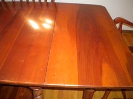 Stunning Solid Cherry Dining Room Table with several leaves and 6 chairs(2 are Captain) Beautiful with fold in legs and drop leaf.