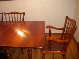 Stunning Solid Cherry Dining Room Table with several leaves and 6 chairs(2 are Captain) Beautiful with fold in legs and drop leaf.