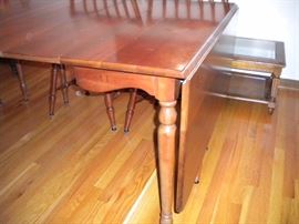 Stunning Solid Cherry Dining Room Table with several leaves and 6 chairs(2 are Captain) Beautiful with fold in legs and drop leaf.