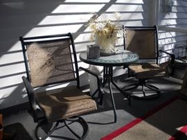 Patio furniture - rocker swivel chairs kept in enclosed patio ,tile top table