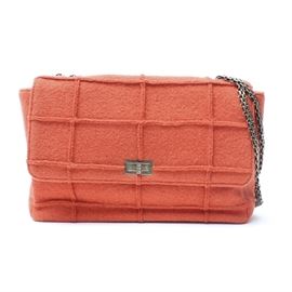 Chanel Wool Single Flap Handbag: A felted wool handbag by Chanel. This salmon colored bag has a fold over flap secured by a Chanel branded metal twist clasp at the front and a double metal chain shoulder strap. It has a cream colored interior compartment with one zippered pocket. The bag has the serial identification sticker present and comes with the plastic identification card as well as a branded black duster bag. The serial number for this bag is 5840076.