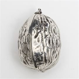 Art Nouveau Sterling Silver Antique Walnut Motif Compact Locket: An antique sterling silver compact locket. This circa 1910 Art Nouveau style locket is fashioned in the shape of a walnut shell. The locket opens from the top to reveal a small removable powder pouf on one side and a small perfume bottle on the other. In the center would have been a small round mirror, now missing.