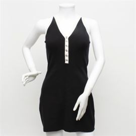 Dolce & Gabbana Maglie Black Sweater Dress: A black and white sweater dress by Dolce & Gabbana Maglie. This black sleeveless dress features white trim along the V-neckline which ends with a center set row of silver-tone buttons. It has a straight line high back and is a size 42.