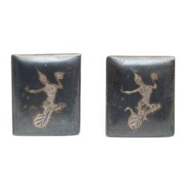 1940s Siam Silver Niello work Vintage Cufflinks: A pair of 1940s vintage Siam silver cufflinks. These sterling silver cufflinks are crafted in the niello work fashion, a special type of black coloring technique. They are from Siam (now Thailand) and have a small engraving in the center depicting Mekkala, The Goddess of Lightning. They are marked on the back, “sterling” and “made in Siam”.