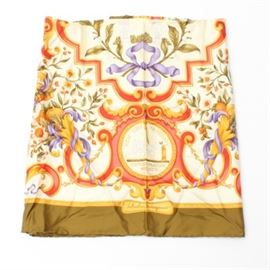 Salvatore Ferragamo Silk Scarf: A silk scarf by Salvatore Ferragamo. This square scarf features a floral and scroll design in red, yellow, purple and green on a cream background. it has a wide olive colored border and is signed, “Salvatore Ferragamo” within the design.