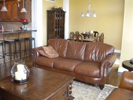 Famous Barr - Leather living room set.. Leather with rolled arms and nailhead trim. Sofa/couch, chair and loveseat.  Dining table and six chairs & China cabinet/Buffet/Hutch. Eddie Bauer coffee and end table. Pottery barn large area rug.