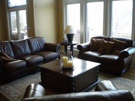 Famous Barr - Leather living room set.. Leather with rolled arms and nailhead trim. Sofa/couch, chair and loveseat.  Eddie Bauer coffee and end table. Pottery barn large area rug.