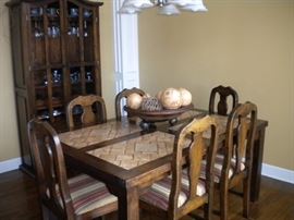 Dining room table with tile top southwest flair, 6 chairs and matching China cabinet/buffet-hutch.