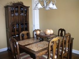 Dining room table with tile top southwest flair, 6 chairs and matching China cabinet/buffet-hutch.