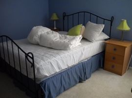 Queen size mattress and box spring and Queen size black iron head/footboard and frame. Quality Danish bedroom night stands.