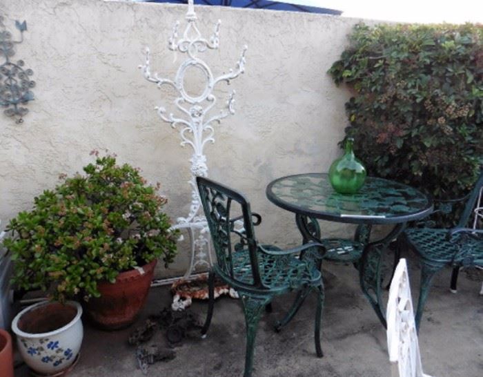 Patio table, two chairs. Antique iron umbrella stand
