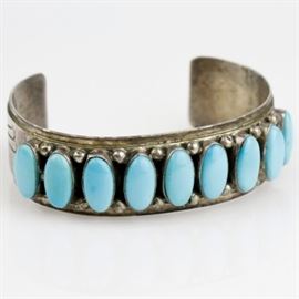 L. James Sterling Silver and Sleeping Beauty Turquoise Cuff: A Native American sterling silver and sleeping beauty turquoise cuff signed by L. James.