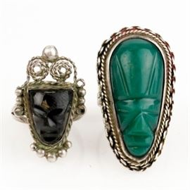 Vintage Sterling Silver and Aztec Warrior Face Rings: A pair of vintage sterling silver Aztec warrior face rings, circa 1960s. Each features a carved stone in the shape of a face with a braided sterling silver border.