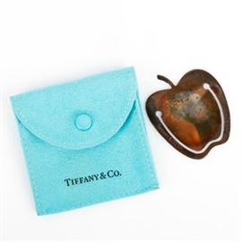 Tiffany & Co. Sterling Silver Apple Bookmark: A Tiffany & Co. sterling silver apple shaped bookmark. It is marked “Tiffany & Co. 925” and has a total approximate weight of 0.22 ozt . Presented in a Tiffany pouch.