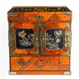 Wooden Jewelry Box with Marquetry and Inlay: A wood box with inlaid wood patterns and geometric designs. The doors have inlaid shell designs of a black background. There is fancy metal hardware and corners. The box has a top compartment, two doors over six drawers, and a larger bottom drawer.
