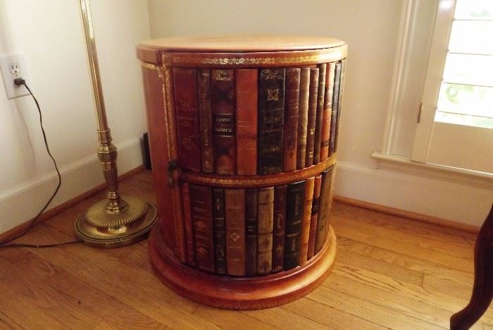 Maitland Smith drum table with faux book spines that conceal an inner cabinet