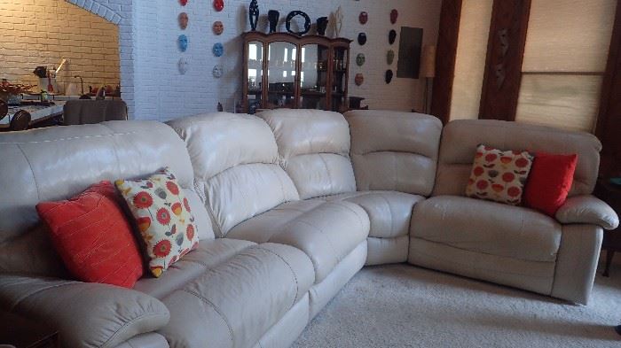 Leather sectional with one manual recliner and two electric recliners.