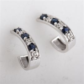 14K White Gold, Sapphire, and Diamond J-Hoop Earrings: A pair of 14K white gold J-hoop earrings featuring alternating sapphires and diamonds with post back closures.
