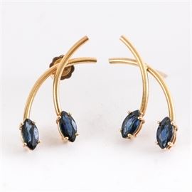 14K Yellow Gold and Marquise Sapphire Bypass Earrings: A pair of 14K yellow gold and faceted marquise cut sapphire bypass style earrings with posts and push back closures.