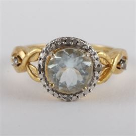Vintage Vermeil, White Spinel, and Diamond Ring: A vintage vermeil ring featuring a center faceted round vermeil gemstone framed by diamonds with an open criss-cross shank.