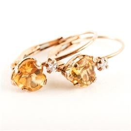 10K Yellow Gold and Citrine Lever Back Earrings: A pair of 10K yellow gold and heart shaped citrine earrings with cubic zirconia accents and lever back closures.