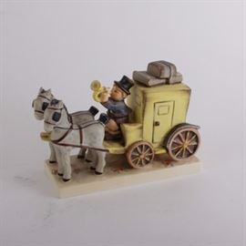 Hummel "The Mail is Here" Porcelain Figurine: A Hummel figurine The Mail is Here. Depicted is a little boy wearing a top hat while riding in on a horse-drawn carriage to deliver the mail. It is marked “226” and “Goebel W Germany”.