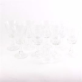 Waterford Crystal "Kenmare" Claret Wine Glasses: A set of eight Waterford Kenmare crystal claret wine glasses. Each glass features a cut crystal conical well, a hexagonal stem, and a round starburst pattern base. They bear the Waterford watermark on their undersides. Also included is a small crystal vase.