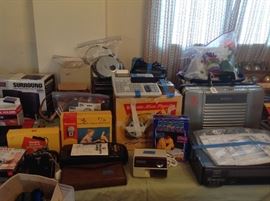 Vintage cameras, Sony camcorder in case, movie projector and screen, surround sound, calculator