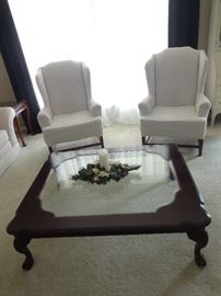Large Glass Coffee Table and White Wingback Chairs 