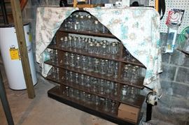 Lots of canning jars and wood shelf