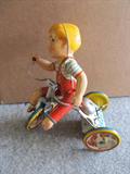 A fabulous lithographed tin toy of a little boy riding a tricycle. He is just amazing, and he works great if he is put on a flat surface. He is marked Kiddy Cyclist Unique Art Mfg. Co. Inc., 200 Fifth Ave. New York, and 200 Waverly Ave., Newark, N.J.. He is 9" high. Wow!!!