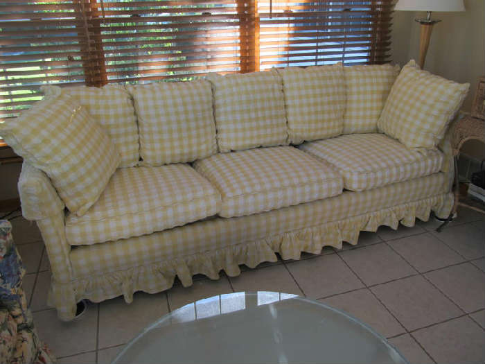 Oh, I love this couch!! The original sofa is from the 1960s, and it is an extremely well made tuxedo style couch. The present owner had it upholstered in this sunny yellow and white check with a ruffled bottom. There are now seven 19" square pillows, five of which go across the back of the couch, and 2 of which are throw pillows. There are also 3 cushions with zipper closures, and these have just been cleaned. This is 88" long and 32" deep. If you need a bright spot in your home, get this! It will make you happy every day!