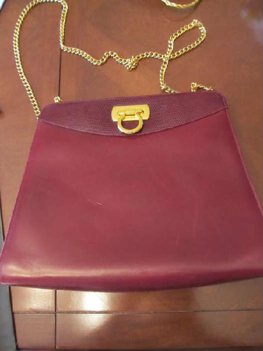 A vintage fabulous Salvatore Ferragamo leather purse. This is, of course, amazing! The owner bought it between 1985 and 1990 in Italy. It is in wonderful condition with only a very few surface scratches (you have to look closely to see them). It is 10" wide and 8.5" high, and it has a brass clasp  with a 42" long gold colored metal shoulder chain strap (it has a great Ferragamo link in it)